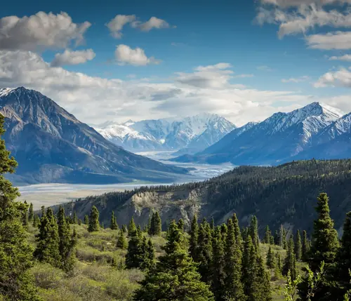 Snow-capped mountains above a green valley